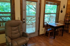 Dining table, chair, and view of the back deck